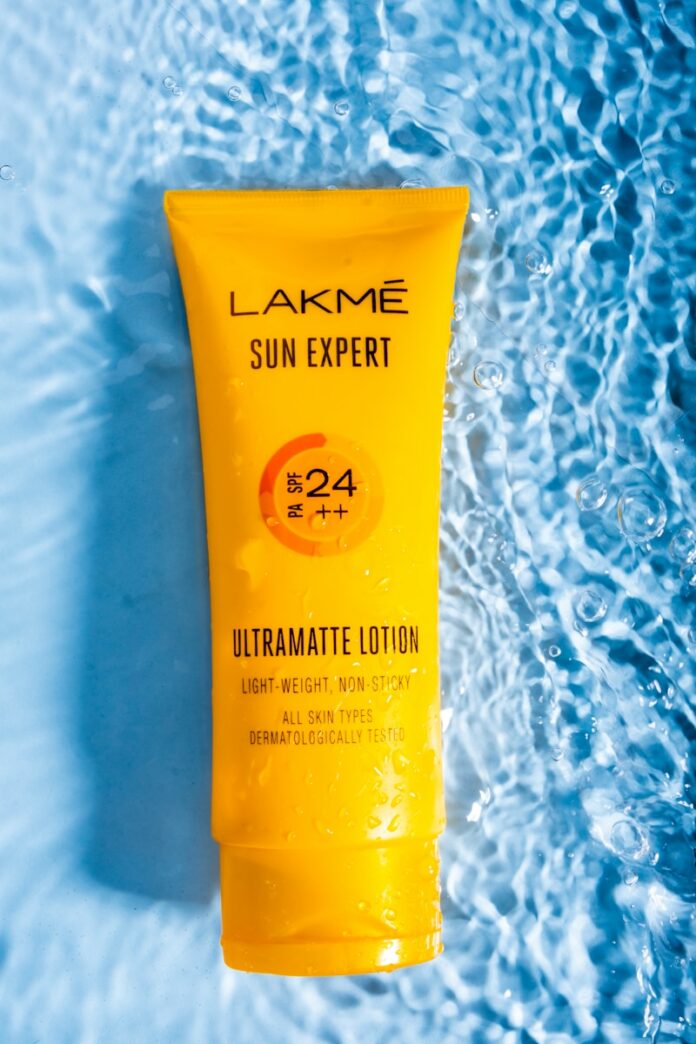 a tube of sunscreen on a blue surface