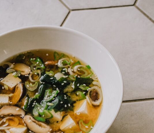 건강한 겨울을 위한 식습관 개선 아이디어 a white bowl filled with soup on top of a tiled floor