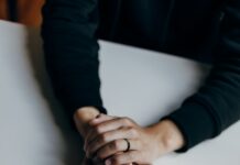 위기 극복을 위한 정신적 회복력 person in black long sleeve shirt holding babys feet