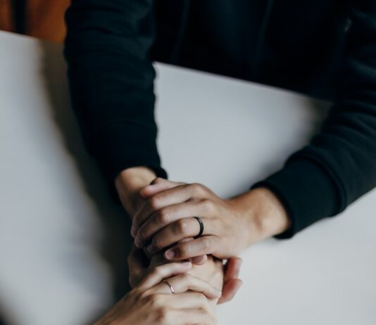 위기 극복을 위한 정신적 회복력 person in black long sleeve shirt holding babys feet