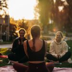 “여성 건강, 일상 속 작은 변화로 지키는 새로운 습관의 힘” a group of people sitting on top of a lush green field