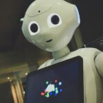 일상 속 AI 건강 관리, 똑똑하게 챙기는 법 white robot toy holding black tablet