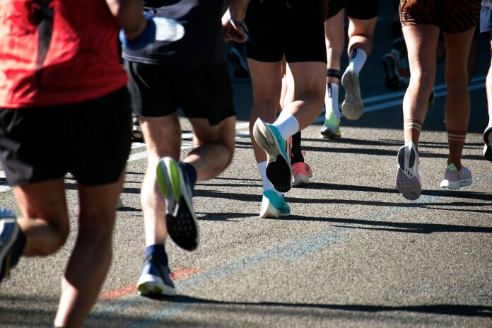 a group of people running down a street